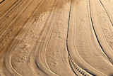 Fototapeta Panele - Tire tracks on an empty beach