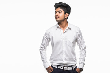 Wall Mural - Portrait of handsome casual business Indian guy smiling, hands in pocket, standing on white background