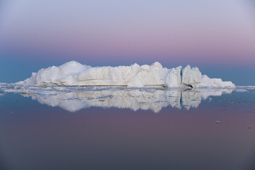 Wall Mural - beautiful iceberg in the pink and purple alpenglow light. disko bay, greenland.