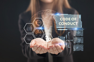 The concept of business, technology, the Internet and the network. A young entrepreneur working on a virtual screen of the future and sees the inscription: Code of conduct