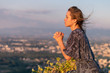 © PhotoGranary - Christian worship and praise. A young woman is praying in the evening.