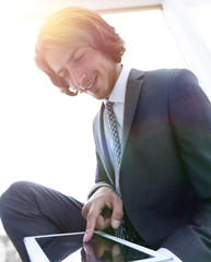 Wall Mural - portrait of successful businessman working on tablet computer.