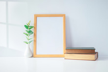 Mock Up Portrait Photo Frame With Green Plant On Table, Home Decoration.