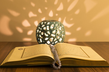 Wall Mural - Koran and rosary beads on the wooden background with lantern or candle for Islamic concept. Holy book quran for Muslims holiday, Ramadan,blessed Friday message.