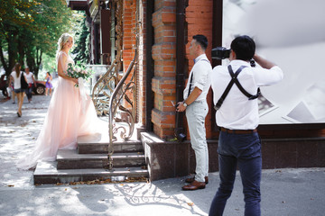 wedding photographer takes pictures of bride and groom