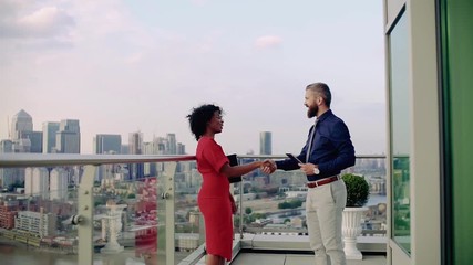 Poster - Two businesspeople standing against London view panorama, shaking hands.