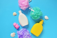 Flat Lay Baby Bath Products. Colorful Sponges, Shampoo Bottle, Liquid Soap, Rubber Toy Hippo And Seashells