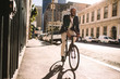 © Jacob Lund - Smiling businessman going to work on bike
