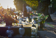 Flowers And Candles On A Colorful Polish Cemetery. Autumn, Preparations For All Saints’ Day.