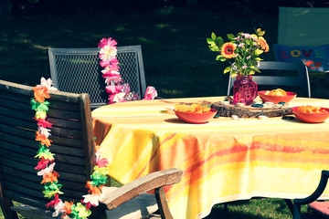 Themed decoration items placed across the garden to hold a child's birthday party outdoors. 