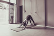 © anon - Asian young woman practicing yoga in  gray background.Young people do yoga at home. Color style sepia.