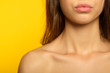female beauty upgrade. girl with radiant skin and plump sexy pout. cosmetology and lip fillers concept. cropped portrait of young woman on yellow background.