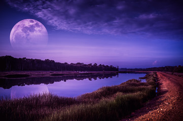 Wall Mural - night sky and super moon at riverside. serenity nature background.