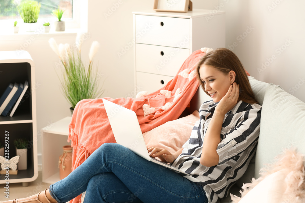 Young woman working on laptop at home