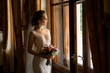 © Wedding photography - Wedding. Portrait of beautiful bride in luxury wedding dress posing near window