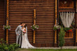 © Wedding photography - Rustic wedding. Stylish bride and groom in love, wedding couple kissing on wooden background.