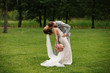 © Wedding photography - Wedding kiss. Elegant bride and groom kissing after wedding ceremony on green background