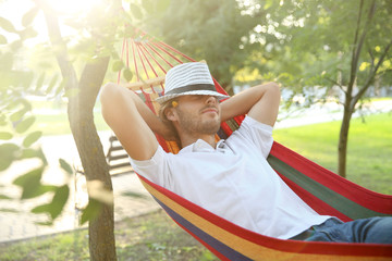 Sticker - Handsome young man resting in hammock outdoors