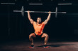 © LIGHTFIELD STUDIOS - handsome fit man working out with barbell in dark gym