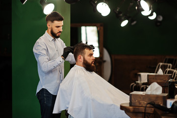 Wall Mural - Handsome bearded man at the barbershop, barber at work.