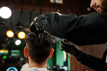 Wall Mural - Handsome bearded man at the barbershop, barber at work.