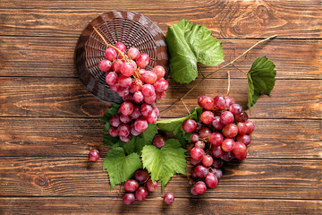 Ripe sweet grapes on wooden table