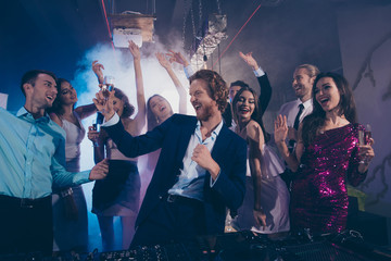 Attractive, handsome man in formal wear dance with glass of beve