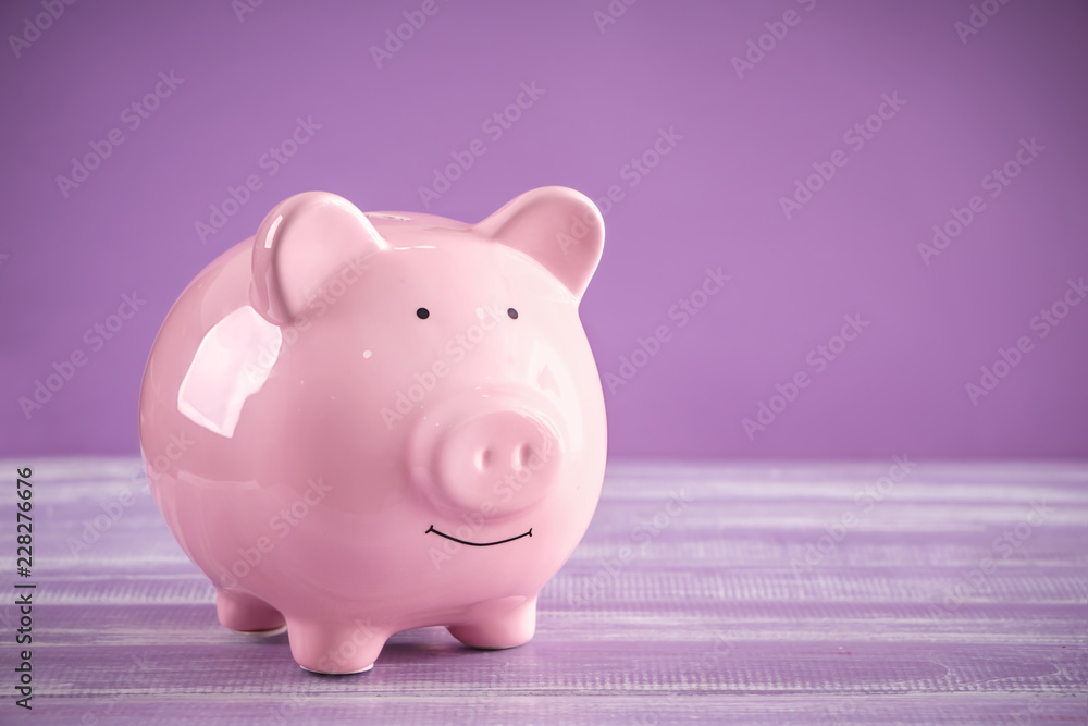 Cute piggy bank on table