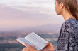Christian worship and praise. A young woman is reading the bible.