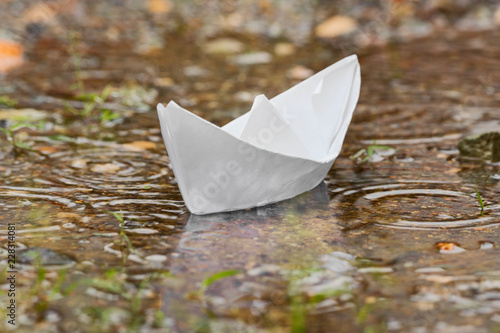 Paper Boat In Puddle After Heavy Tropical Rain In Rainy