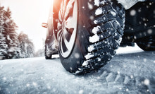 Closeup Of Car Tires In Winter On The Road Covered With Snow