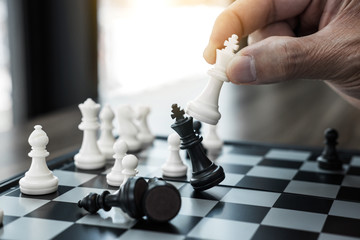 Wall Mural - Businessman's hand playing chess game to development analysis new strategy plan, business strategy leader and teamwork concept for win and success