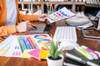 © Freedomz - Image of female creative graphic designer working on color selection and drawing on graphics tablet at workplace with work tools and accessories