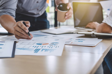 Business team colleagues discussing working analysis with financial data and marketing growth report graph in team, Meeting Talking Brainstorming Communication Concept