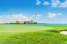 Golf Ball On Green At Golf Course On The Ocean Blue Sky As Backgroud