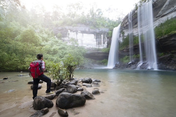 Sticker - backpacker standing infront of waterfall