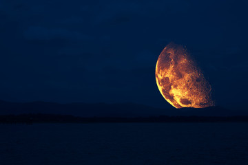 Wall Mural - half moon floating in sky back on silhouette mountain