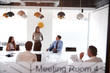 © Monkey Business - Businesswoman Giving Boardroom Presentation Viewed Through Meeting Room Window