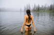 © Forrest Smith - Back view of woman standing in water