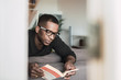 © ADDICTIVE STOCK - Handsome adult man reading book at home