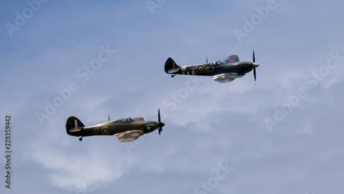 RAF World War 2 Spitfire (above) and Hurricane flying in formation Fototapete