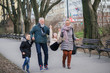 Grandparents having fun with their grandchildren in city park.