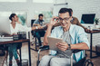 © VadimGuzhva - Man in Glasses on Wheelchair with Tablet in Office