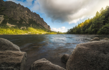 Wall Mural - Mountain Lake with Rocks in Foreground. Poprad Tarn, High Tatras, Slovakia.