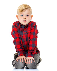 A cute little boy in a shirt and shorts.