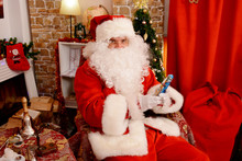 Santa Claus Holding Christmas Figurine