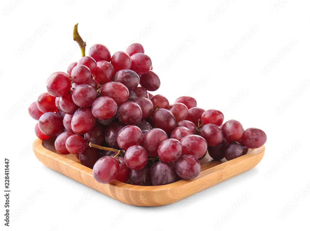 Wooden tray with fresh grapes on white background