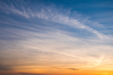 Fototapeta Zachód słońca - Sunset sky with curve cloud in blue and yellow color