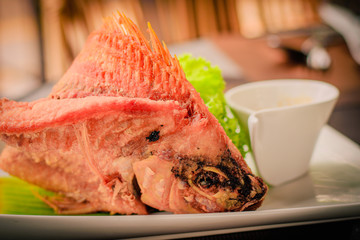 Wall Mural - Deep-fried flying fish served with sweet-and-spicy dark sauce