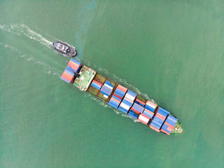 Aerial view of Small container ship at sea freight, Business International trade and Container logistics export-import harbor to the International port / Shipping Containers concept.